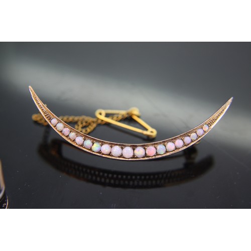 317 - 15ct gold opal crescent shaped brooch, 5.5 grams total
