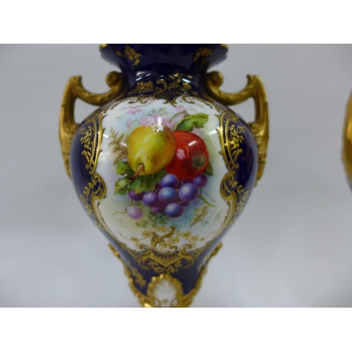 109 - A pair of Royal Worcester vases with gilt twin handles and hand painted fruit panels, signed Hawkins... 