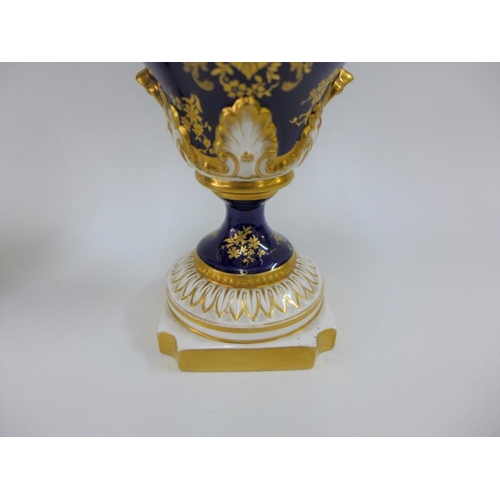 109 - A pair of Royal Worcester vases with gilt twin handles and hand painted fruit panels, signed Hawkins... 