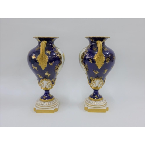 109 - A pair of Royal Worcester vases with gilt twin handles and hand painted fruit panels, signed Hawkins... 