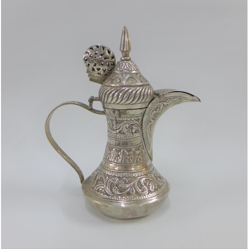 11 - Indian white metal coffee pot of small proportions, with hinged lid  and covered spout, base stamped... 