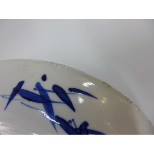 111 - Chinese porcelain shallow dish, the blue ground painted with a figure to the centre,( fritting to un... 