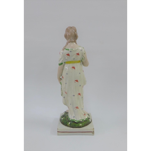 79 - Late 18th / early 19th century Staffordshire pearlware figure of Venus, modelled standing holding a ... 