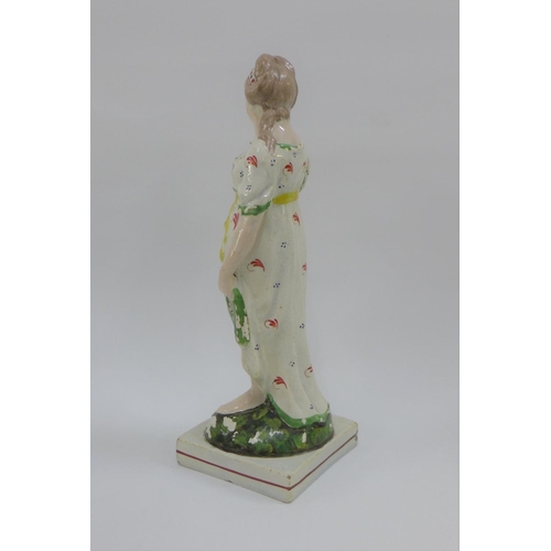 79 - Late 18th / early 19th century Staffordshire pearlware figure of Venus, modelled standing holding a ... 