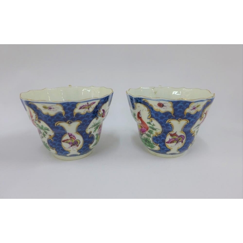 80 - Pair of Dr Wall Worcester cups and saucers, in exotic bird pattern to a blue scale ground, one sauce... 