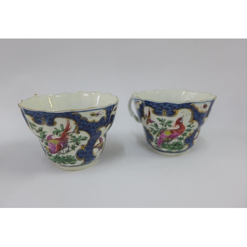 80 - Pair of Dr Wall Worcester cups and saucers, in exotic bird pattern to a blue scale ground, one sauce... 