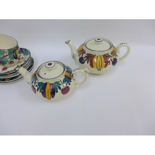 106 - Scottish handpainted pottery table wares to include teapots, cups and saucers, etc (13)