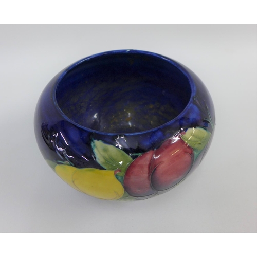 68 - Moorcroft bowl the blue ground tubeline decorated with fruit, with facsimile signature to the base a... 