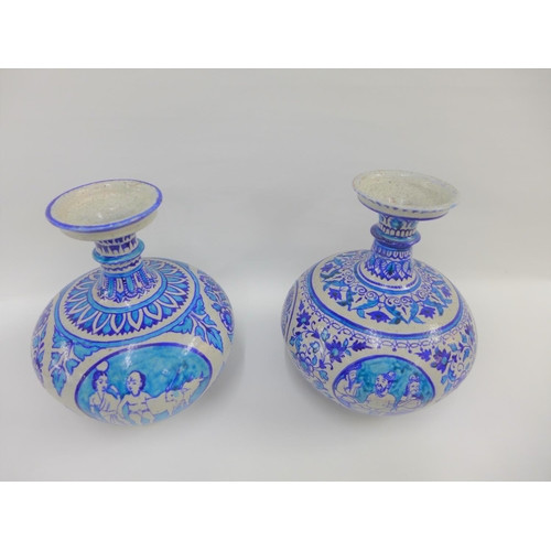 81 - A pair of Middle Eastern style bottle neck vases, painted with flowers and figures to a turquoise gr... 