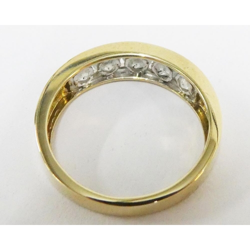 10 - 9ct gold ring, chanel set with five diamonds, stamped 1.00ct and with full set of hallmarks, UK ring... 