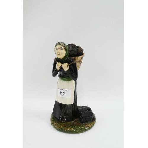 115 - Coll Pottery female figure, modelled standing with a peat basket on her bag, 22cm high