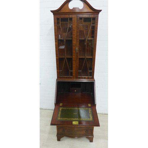 275 - Mahogany veneered bureau bookcase with a broken swan neck pediment over a pair of glazed cupboards w... 