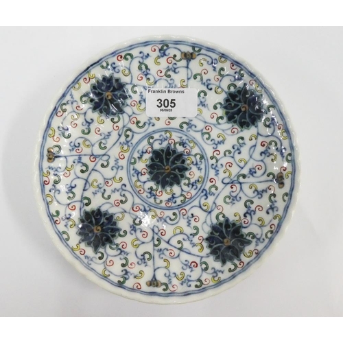 305 - Chinese saucer dish of circular lobed form, in a five colour palette depicting flowers and scrolling... 