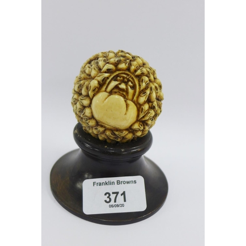 371 - Carved ivory ball depicting '1000 rats' on a hardwood stand, approx 6cm wide