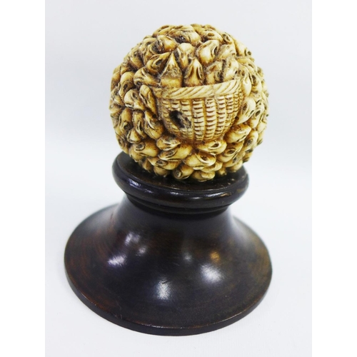 371 - Carved ivory ball depicting '1000 rats' on a hardwood stand, approx 6cm wide