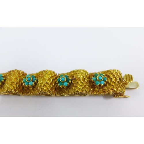 39 - Vintage 18ct gold bracelet with eleven textured panels set with turquoise flowerheads, stamped 18K, ... 