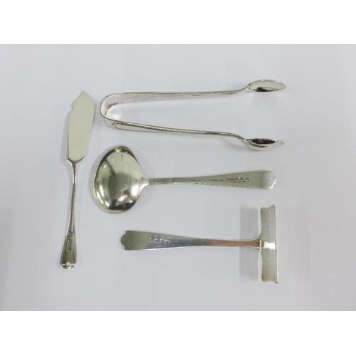 44 - Silver items to include a pair of sugar tongs, pusher, butter knife and small ladle spoon (4)