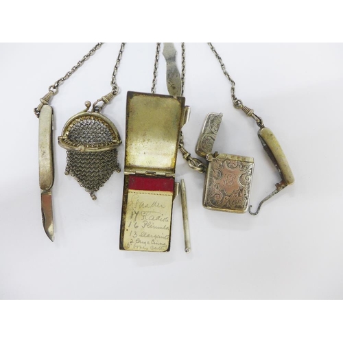 50 - Continental silver chatelaine hung with a Birmingham silver vesta case, two white metal fruit / pen ... 