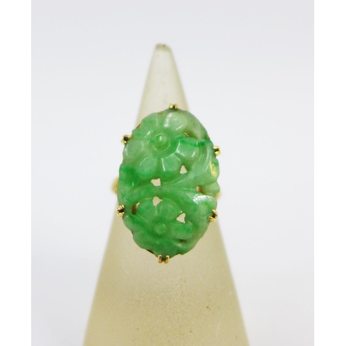 56 - 18ct gold ring claw set with a jade floral carved plaque, UK ring size M together with a strand of g... 