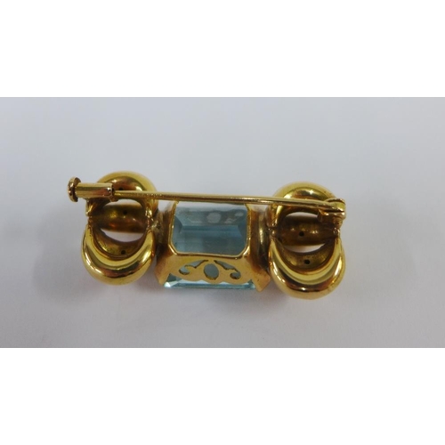 57 - Unmarked gold brooch claw set with a baguette cut gemstone, 4cm