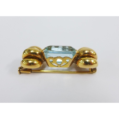 57 - Unmarked gold brooch claw set with a baguette cut gemstone, 4cm