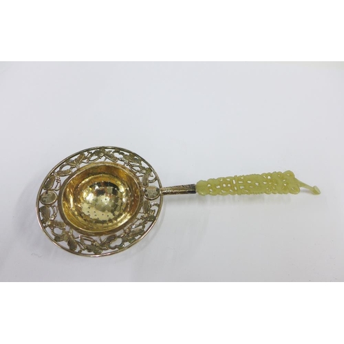 70 - Chinese silver tea strainer, the pierced bowl with butterfly pattern border and with a carved jade h... 