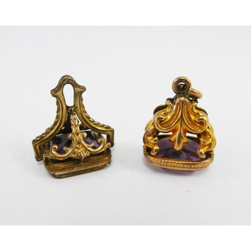 104 - Two amethyst seal fobs, (2)