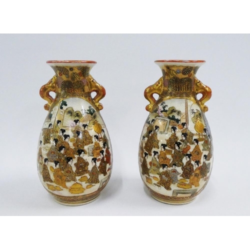 123 - Pair of Japanese Satsuma earthenware vases, with gild handles and painted with figures, character ma... 