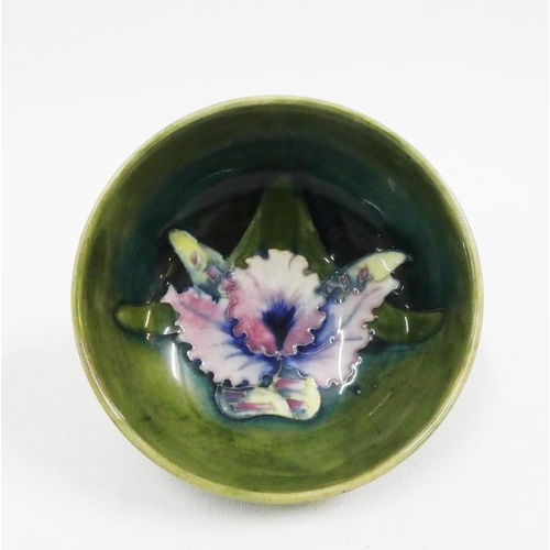 138 - Moorcroft green glazed bowl tubeline decorated with Orchids, bearing impressed facsimile signature a... 