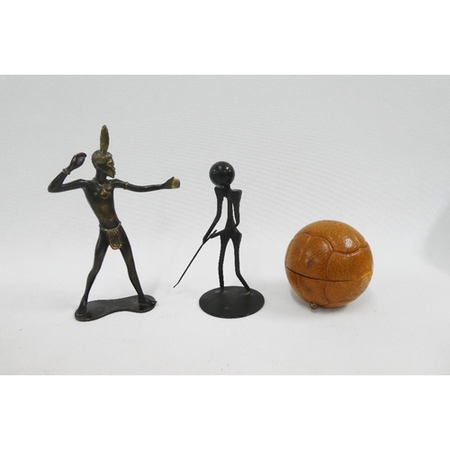 142 - Mixed lot to include an Austrian bronze figure, black metal golfing figure and a leather cased novel... 