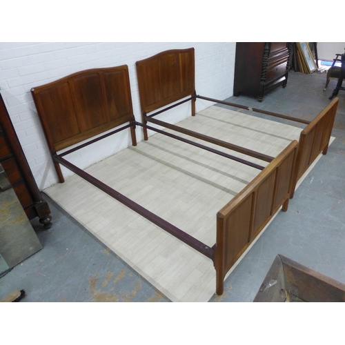 230 - Pair of Gordon Russell three fielded panel walnut beds, on chamfered supports, complete with side ra... 