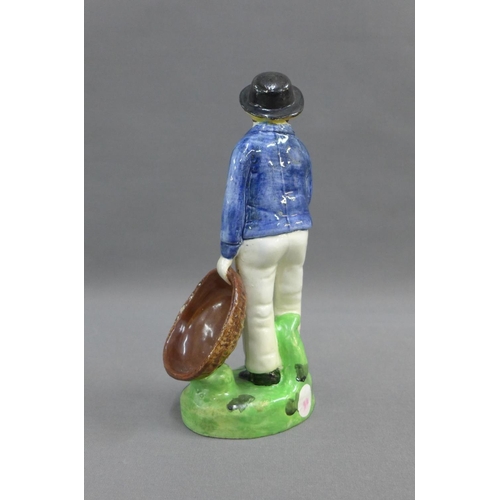 61 - Early 19th century earthenware figure of a man, probably Portobello pottery. modelled standing in hi... 