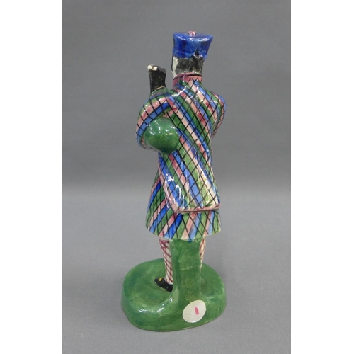 64 - Early 19th century Portobello pottery figure of a Bagpiper, modelled standing in his tartan jacket a... 