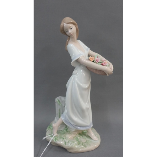 67 - Lladro Privilege society 2004 figure of a girl with a  basket of flowers, 26cm high