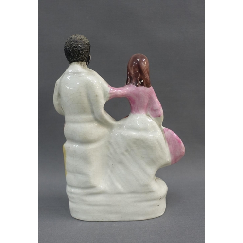 78 - Eva & Uncle Tom, a 19th century Staffordshire flatback figure, on oval lined base, 23cm high