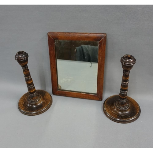 339 - Pair of oak knop stemmed candlesticks and a small wall mirror with rectangular plate, 23cm high (3)