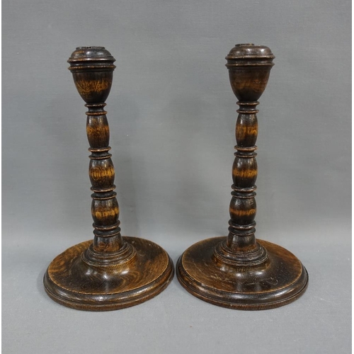 339 - Pair of oak knop stemmed candlesticks and a small wall mirror with rectangular plate, 23cm high (3)