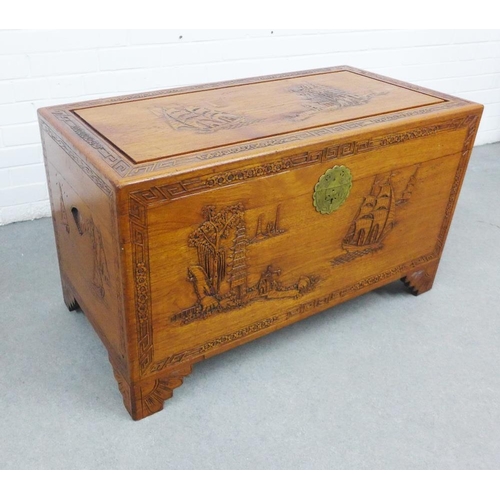 441 - Camphor wood blanket box / storage trunk, with hinged lid and void interior, carved with a pagoda an... 