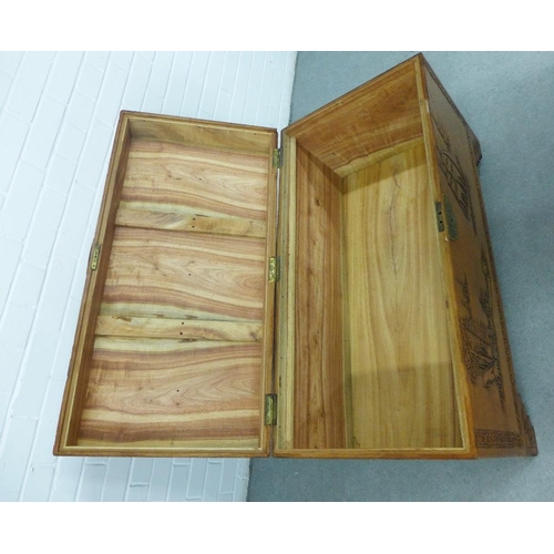 441 - Camphor wood blanket box / storage trunk, with hinged lid and void interior, carved with a pagoda an... 