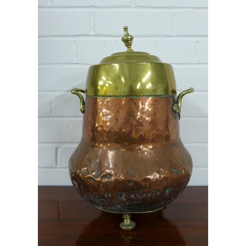 446 - Copper and brass urn vessel, with handles to side and raised on three bun feet, 43cm high