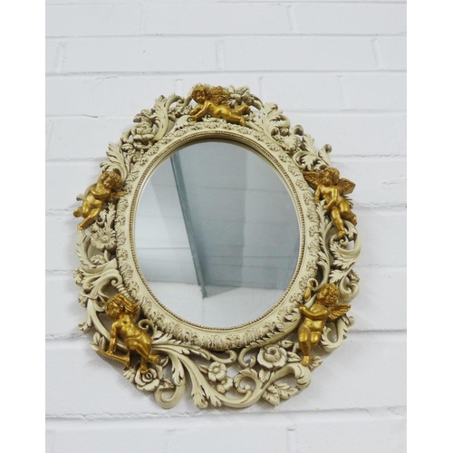 447 - Oval wall mirror with pierced foliate frame with faux giltwood cherubs, 40 x 33cm