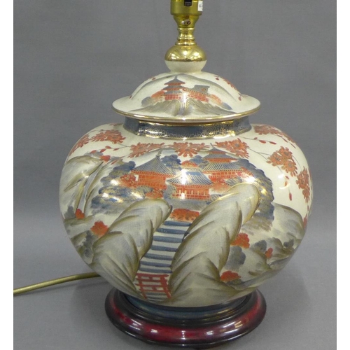 452 - Satsuma table lamp base of lobed form and painted with pagodas and a blossom landscape, with signatu... 