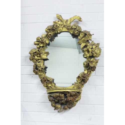 456 - Floral giltwood mirror with pier shelf, the oval plate surmounted with a ribbon swag within a surrou... 