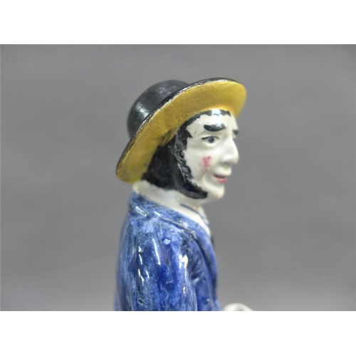 61 - Early 19th century earthenware figure of a man, probably Portobello pottery. modelled standing in hi... 