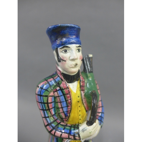 64 - Early 19th century Portobello pottery figure of a Bagpiper, modelled standing in his tartan jacket a... 