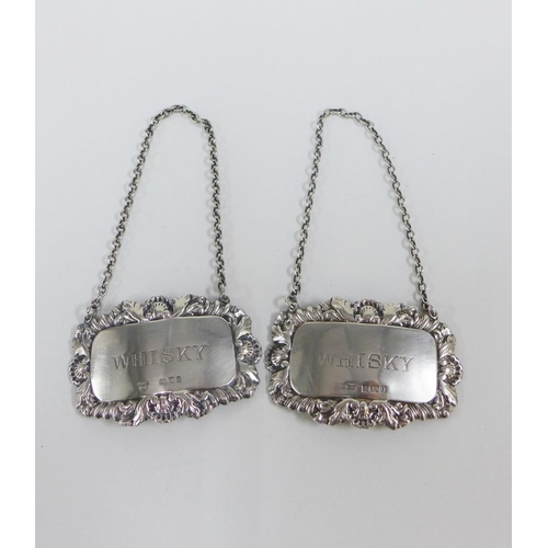 84 - A pair of gurgle glass decanters with stoppers and each with a Birmingham silver 'Whisky' decanter l... 