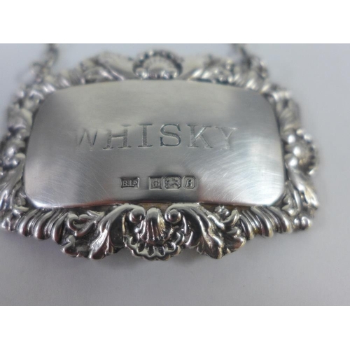 84 - A pair of gurgle glass decanters with stoppers and each with a Birmingham silver 'Whisky' decanter l... 