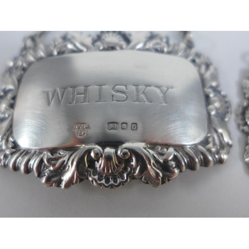 84 - A pair of gurgle glass decanters with stoppers and each with a Birmingham silver 'Whisky' decanter l... 