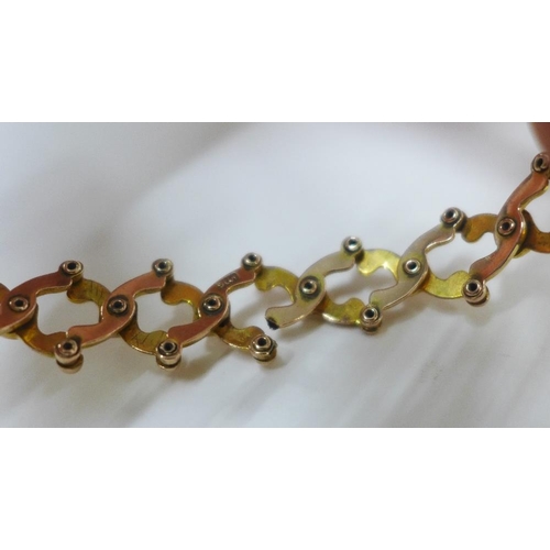 14 - Early 20th century 9ct gold expanding bracelet, centred with a clover motif of three opals with a su... 