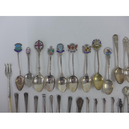 65 - A quantity of silver and white metal souvenir teaspoons, pickle forks, etc (a lot)